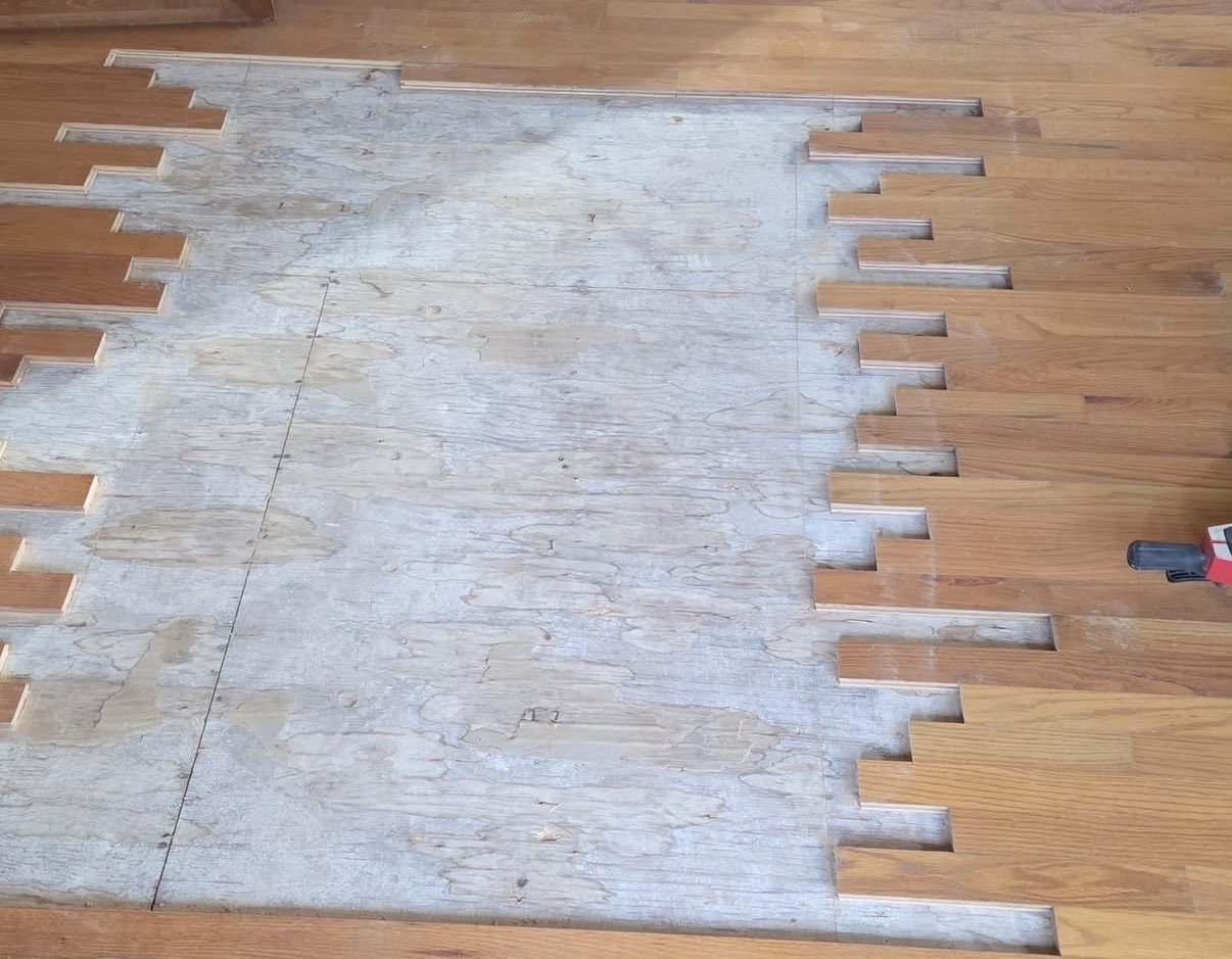 Board replacement laced into an existing oak floor mid-repair